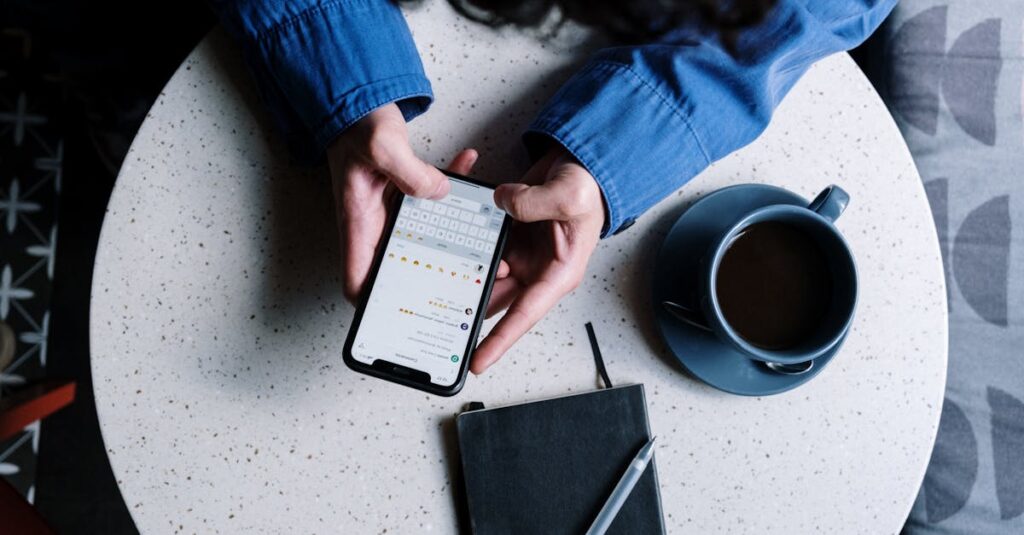 pexels-photo-5053740-5053740 Person using smartphone at table with notebook and coffee, ideal for tech and lifestyle themes.